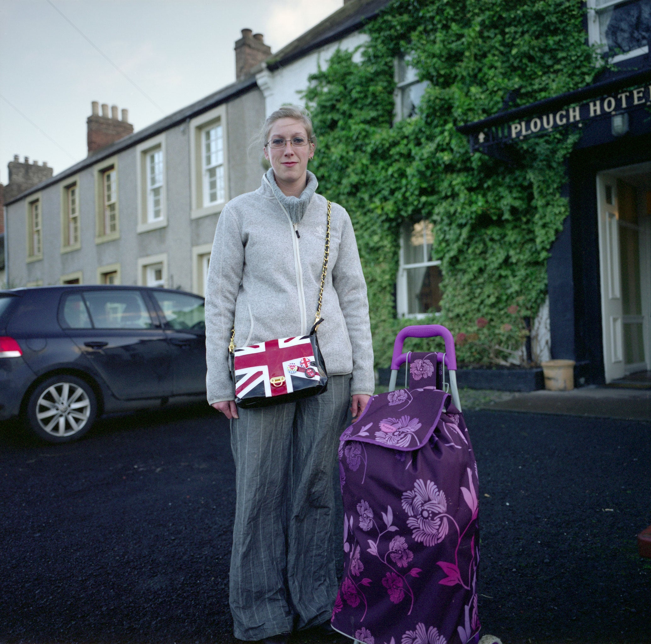 'Woman with a Union Jack Bag, Yetholm': this woman was waiting at a bus stop; she was heading to nearby Kelso to go shopping