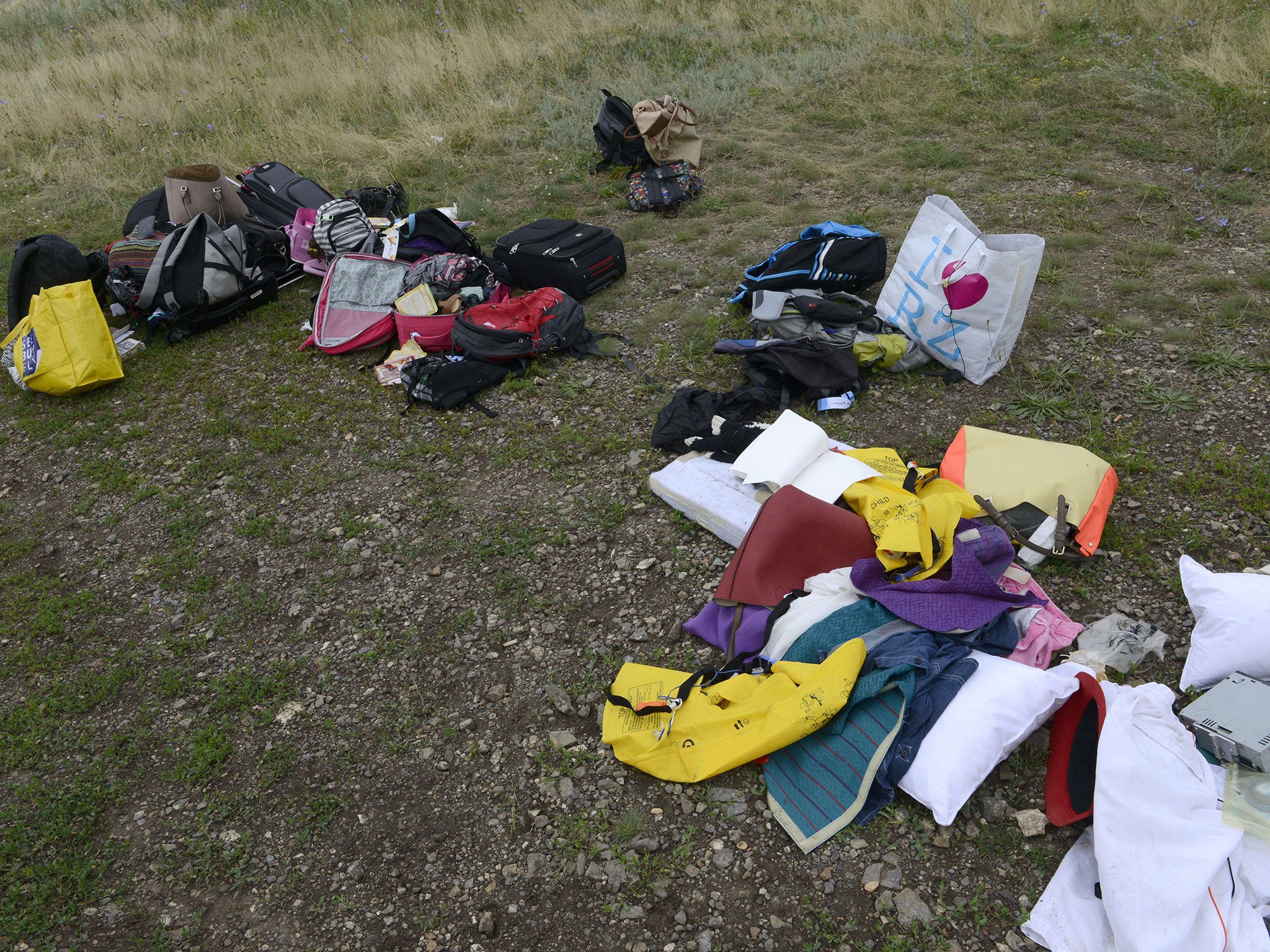 Passengers' belongings lie at the site of the crash