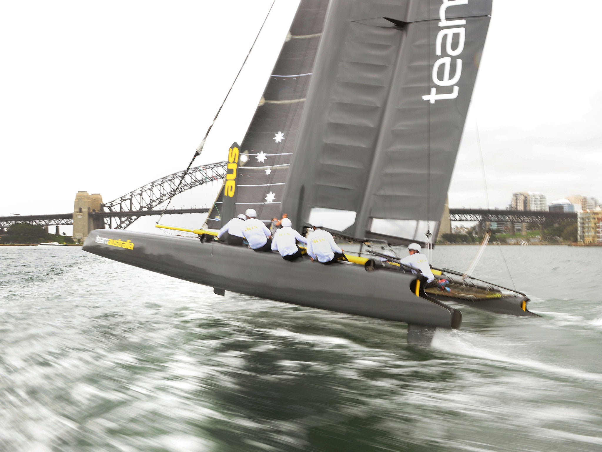 Team Australia's new AC45 catamaran speeds over the water during its first outing on Sydney Harbour