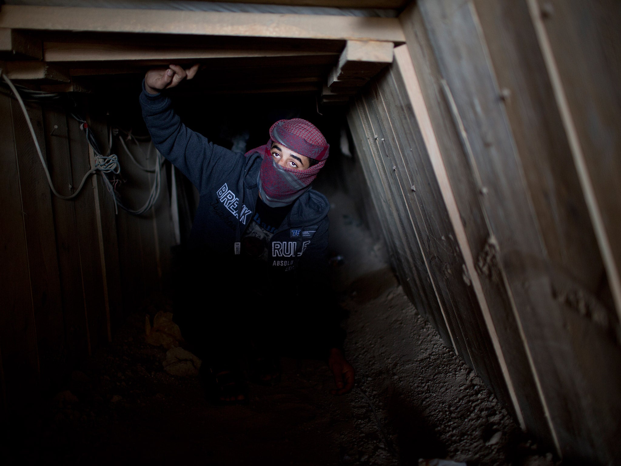 A Palestinian man works inside a smuggling tunnel beneath the Gaza-Egypt border, in Rafah in the southern Gaza Strip, last year