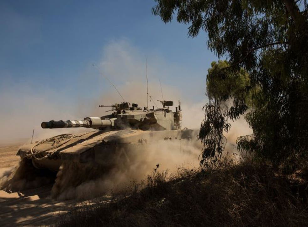 An Israeli tank on its way to the border with Gaza yesterday 