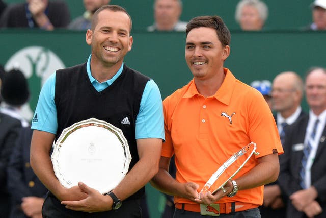 Sergio Garcia and Rickie Fowler stand with their awards for joint second place
