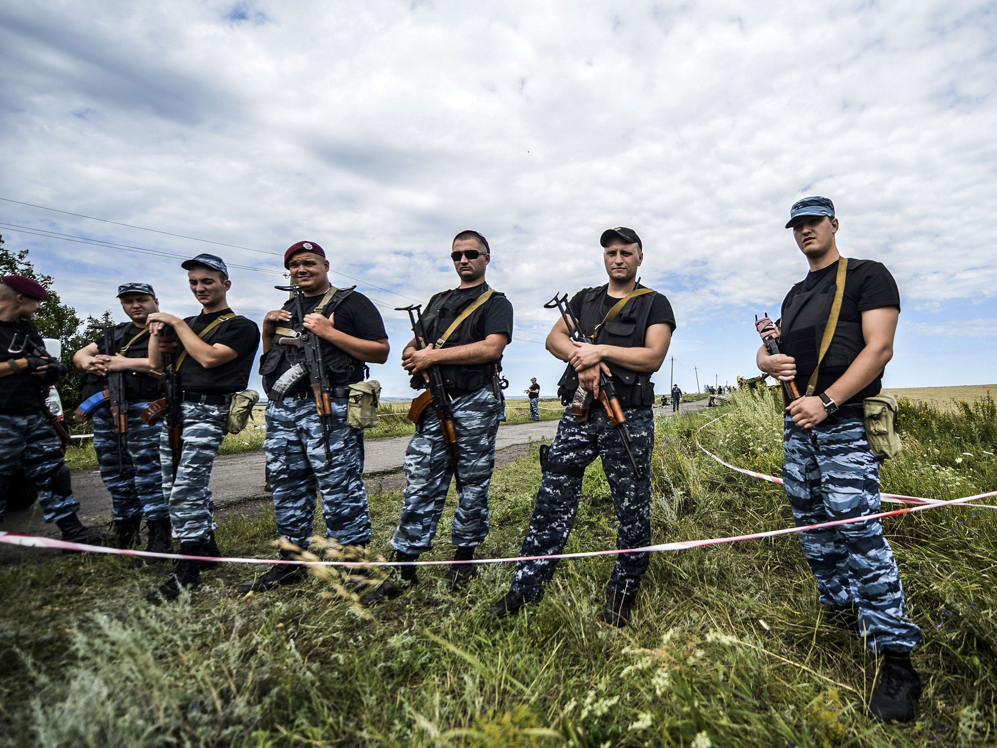 Pro-Russian separatists block the way to the crash site of MH17, near the village of Grabove