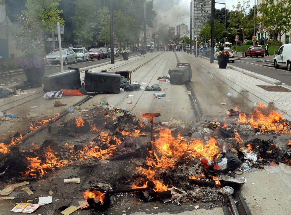 Burning detritus are seen along the tramway line in Sarcelles, a suburb north of Paris, on July 20, 2014, after clashes following a demonstration denouncing Israel's military campaign in Gaza