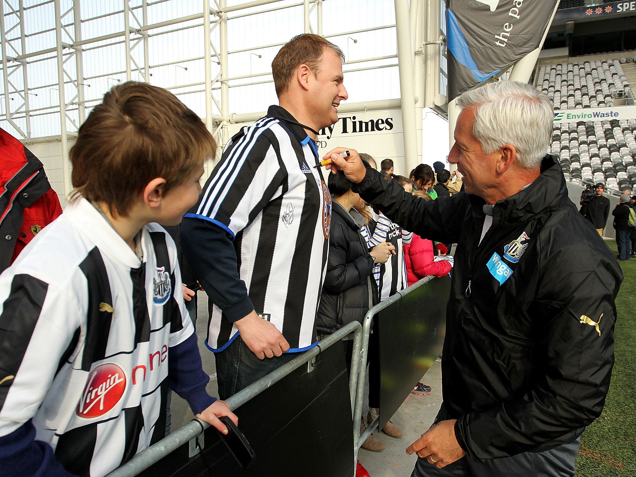 Newcastle manager Alan Pardew signs a Newcastle fans' shirt on the pre-season tour in New Zealand