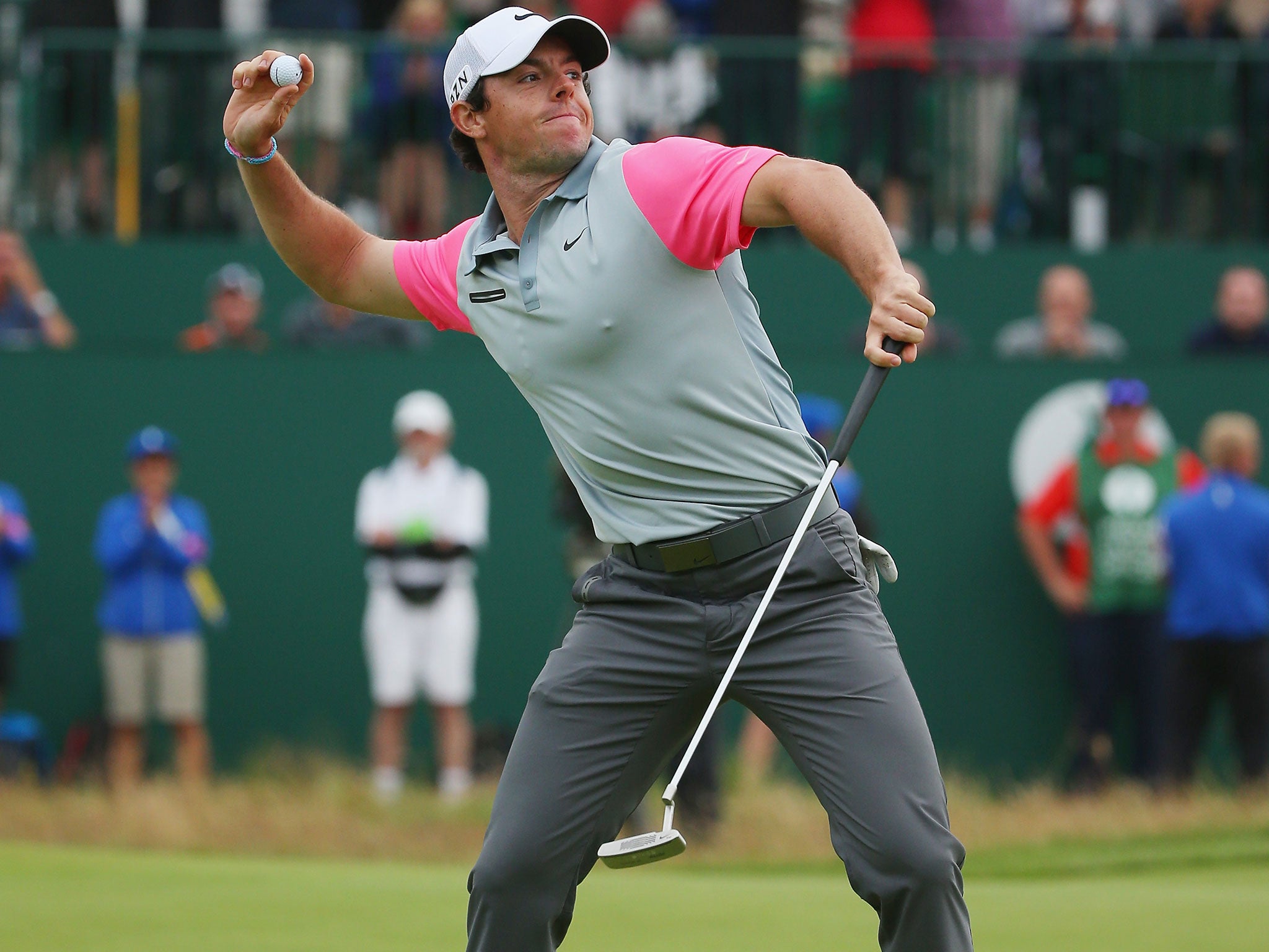 Rory McIlroy throws his ball into the crowd in celebration of his 2014 Open Championship
