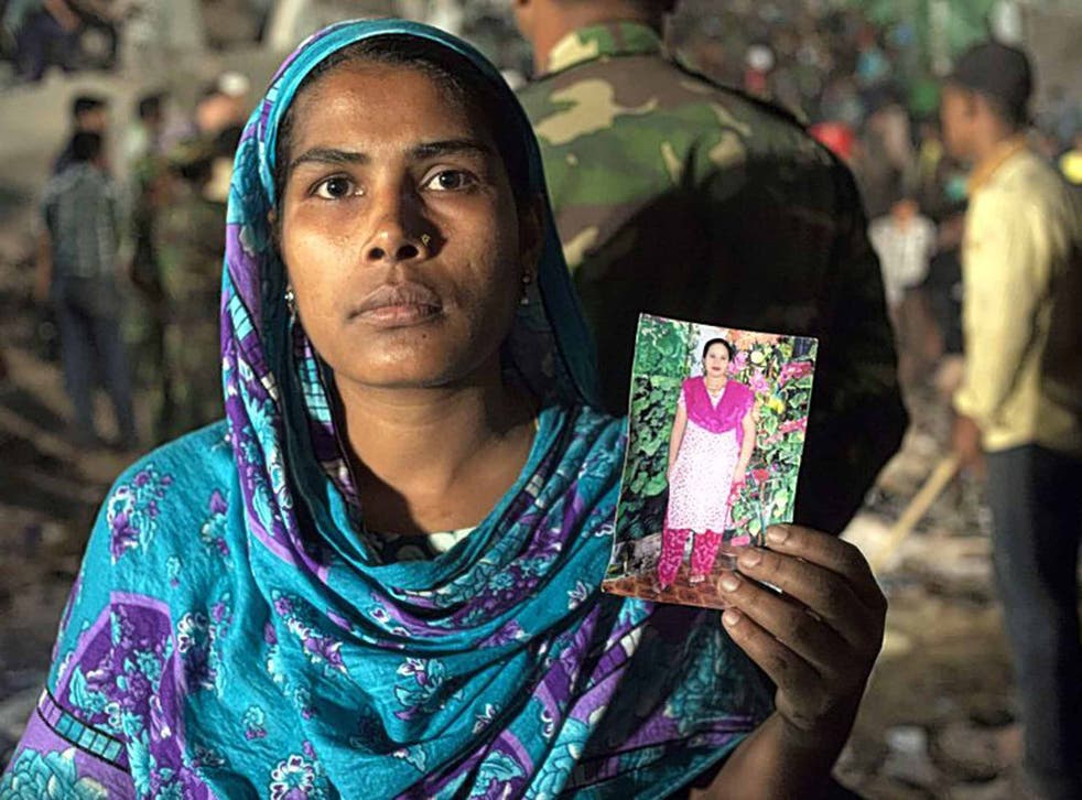 Family tragedy: a woman holding a picture of her missing relative after the Rana Plaza collapse in Bangladesh last year 