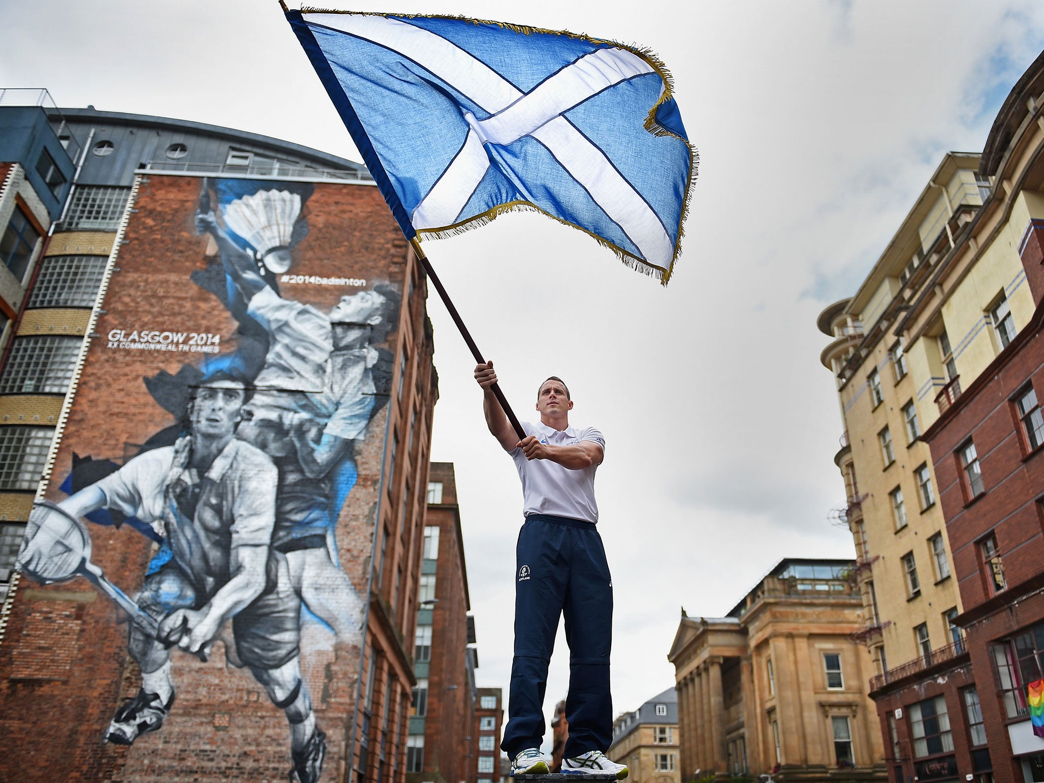 Euan Burton, multiple World and European medal winning judoka poses with the Scottish Saltire flag
