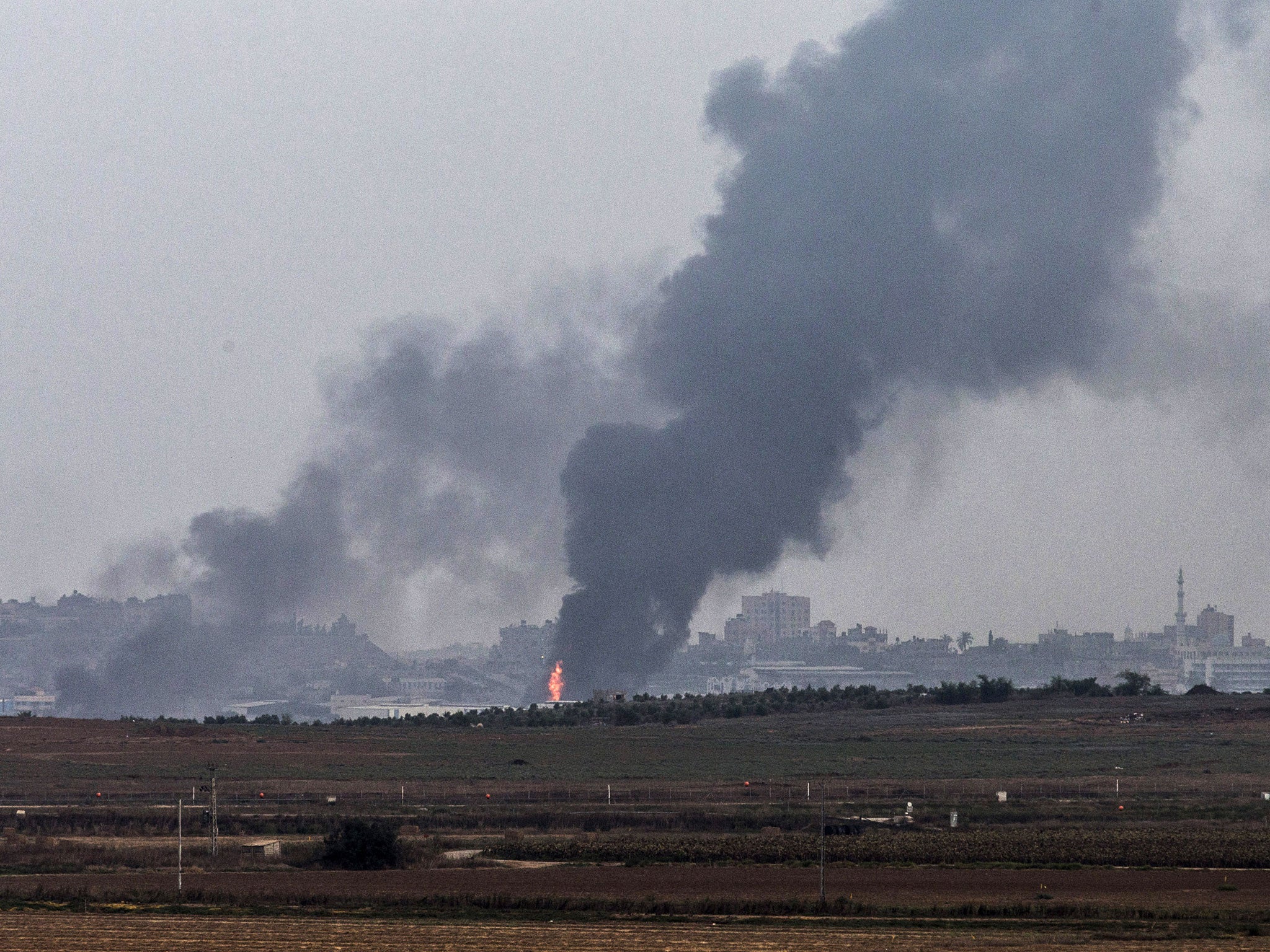 Smoke due to airstrikes and shelling rises from Gaza on July 22, 2014 as seen from near Sderot, Israel