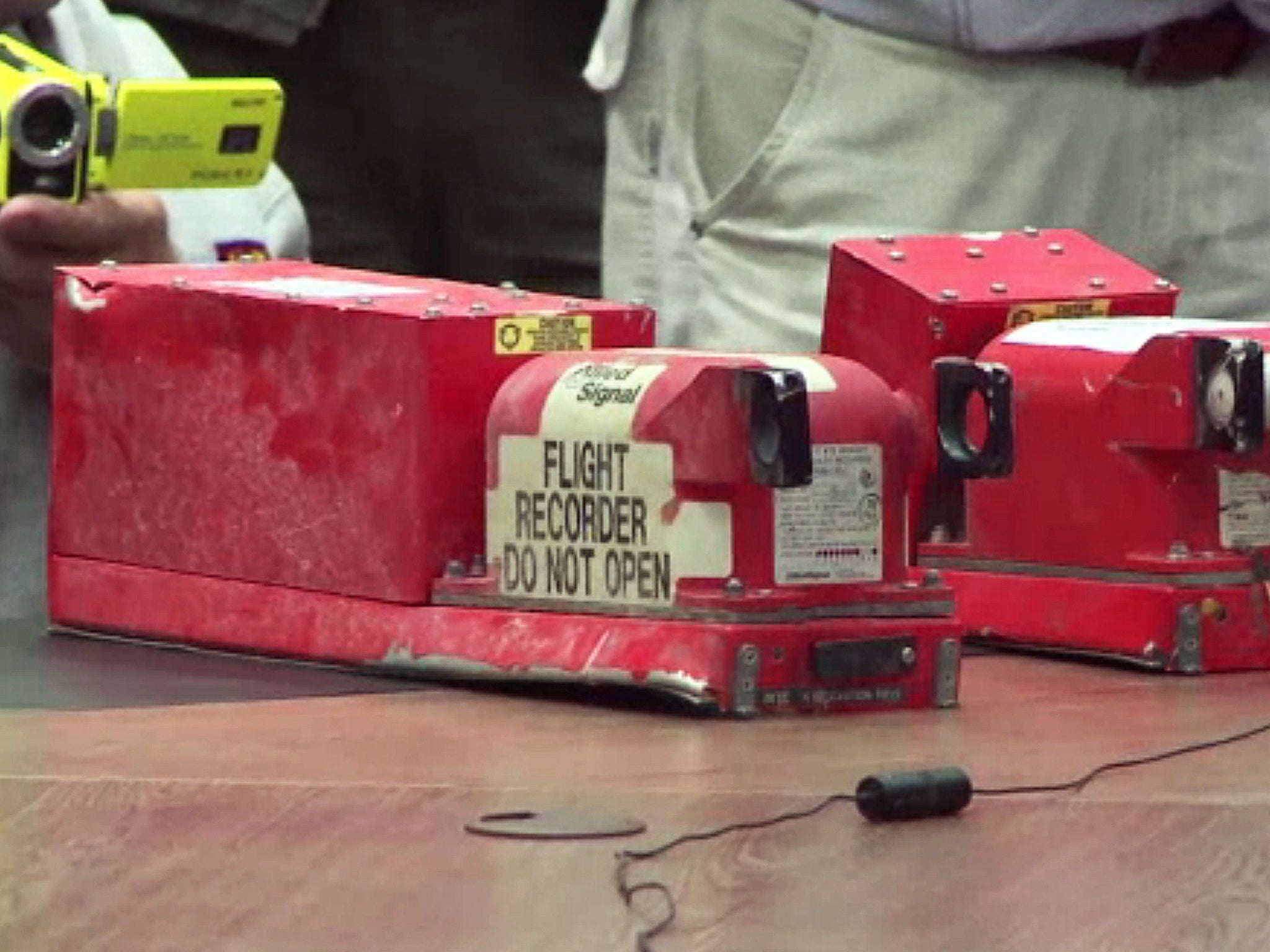 Two black boxes recovered from the crash site of the MH17 jet being handed over to Malaysian officials during a press conference in Donetsk 