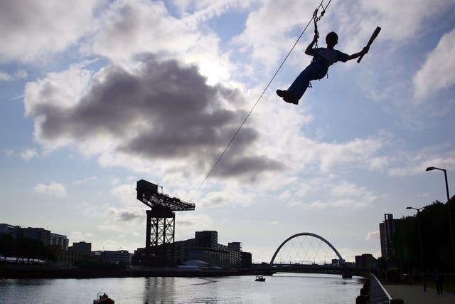 Batonbearer 010 Nina Saunders carrying the Glasgow 2014 Queen's Baton on a zip wire from Finnieston Crane in Glasgow 