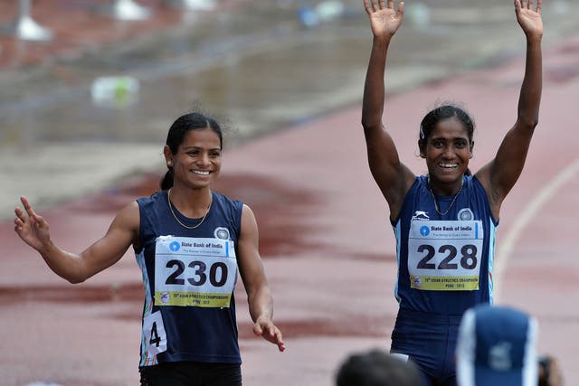 Dutee Chand (l), who has been barred from the Commonwealth Games, waves to the crowd at the 2013 Asian Athletics Championships