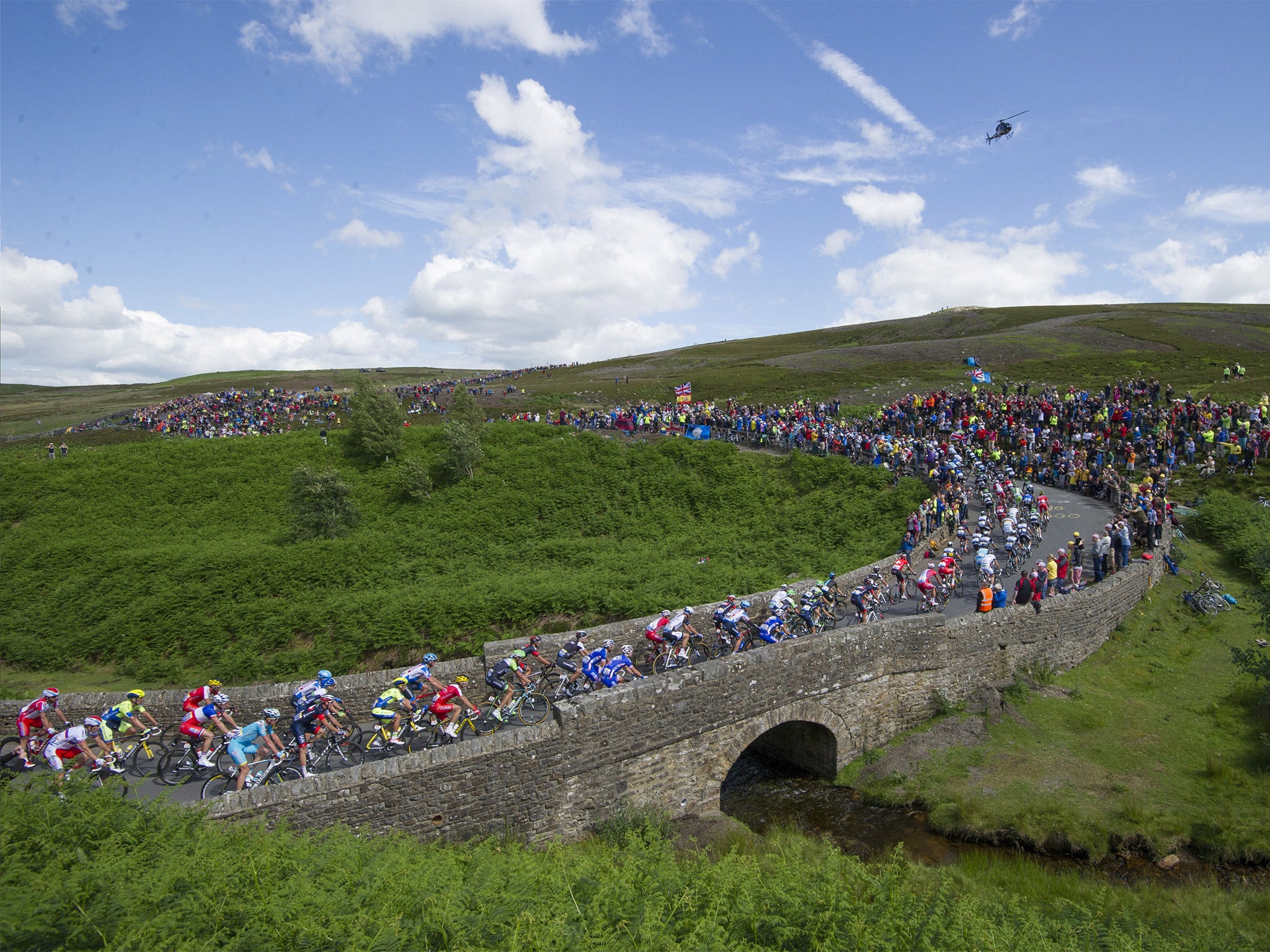 The Tour de France peloton rides over a bridge on the Grinton Moor, Yorkshire, earlier this month