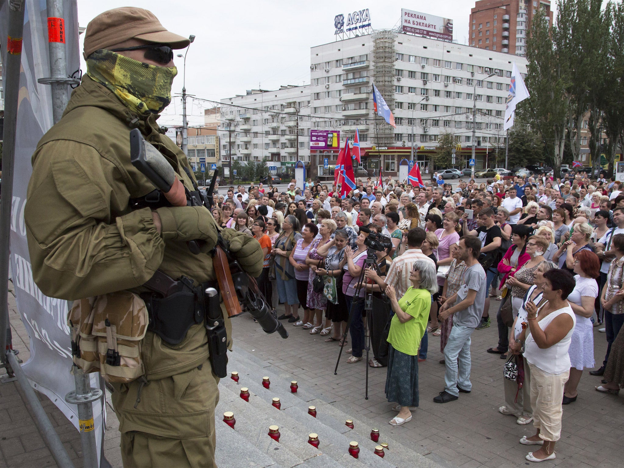 A Donetsk People's Republic fighter stands guard during a pro-Russian meeting in the city of Donetsk earlier this month