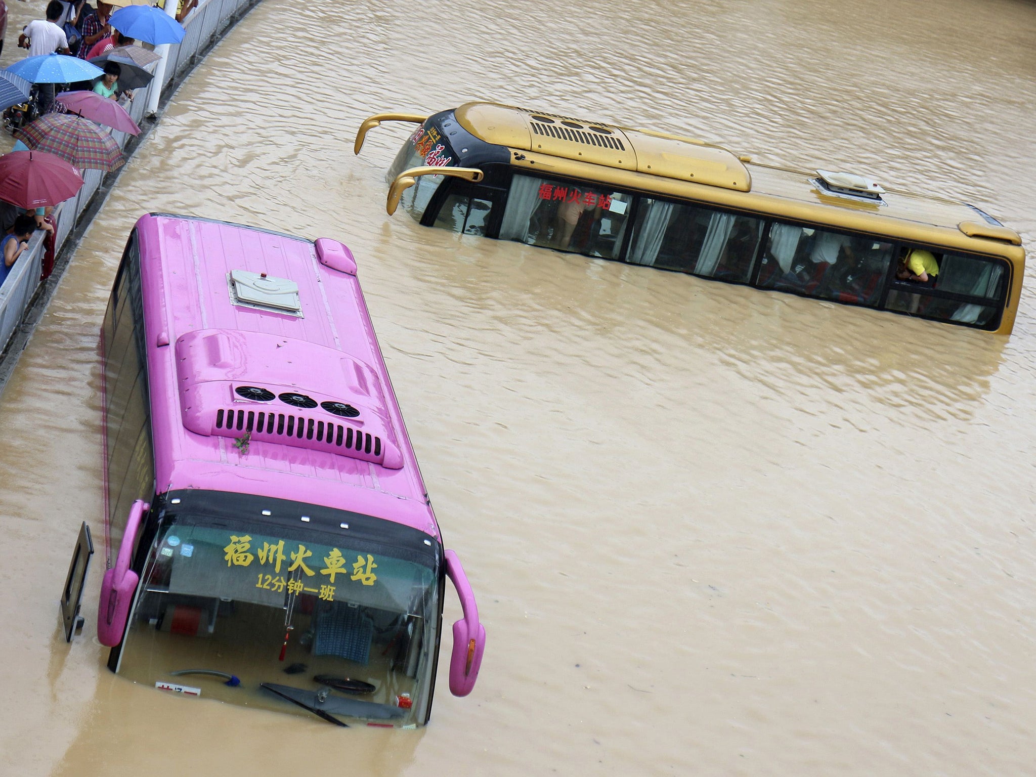 Buses are stranded in a flooded street in Fuzhou, Fujian province