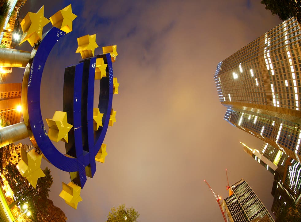 The euro sign landmark is seen at the headquarters (R) of the European Central Bank (ECB) in Frankfurt