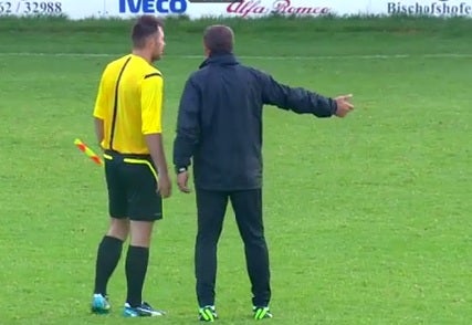 A member of Maccabi Haifa's staff speaks to the referee as the match is abandoned