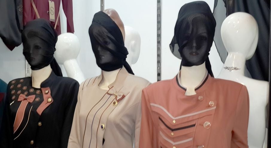 In this Monday, July 21, 2014 photo, mannequins with their faces covered are displayed in a shop window in central Mosul, 225 miles (360 kilometers) northwest of Baghdad, Iraq. The Islamic State group ordered clothes shop owners to cover the faces of the 