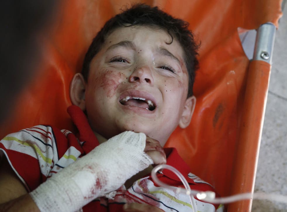 A Palestinian child, wounded in an Israeli strike on a compound housing a UN school in Beit Hanoun, in the northern Gaza Strip, cries at the emergency room of the Kamal Adwan hospital in Beit Lahiya