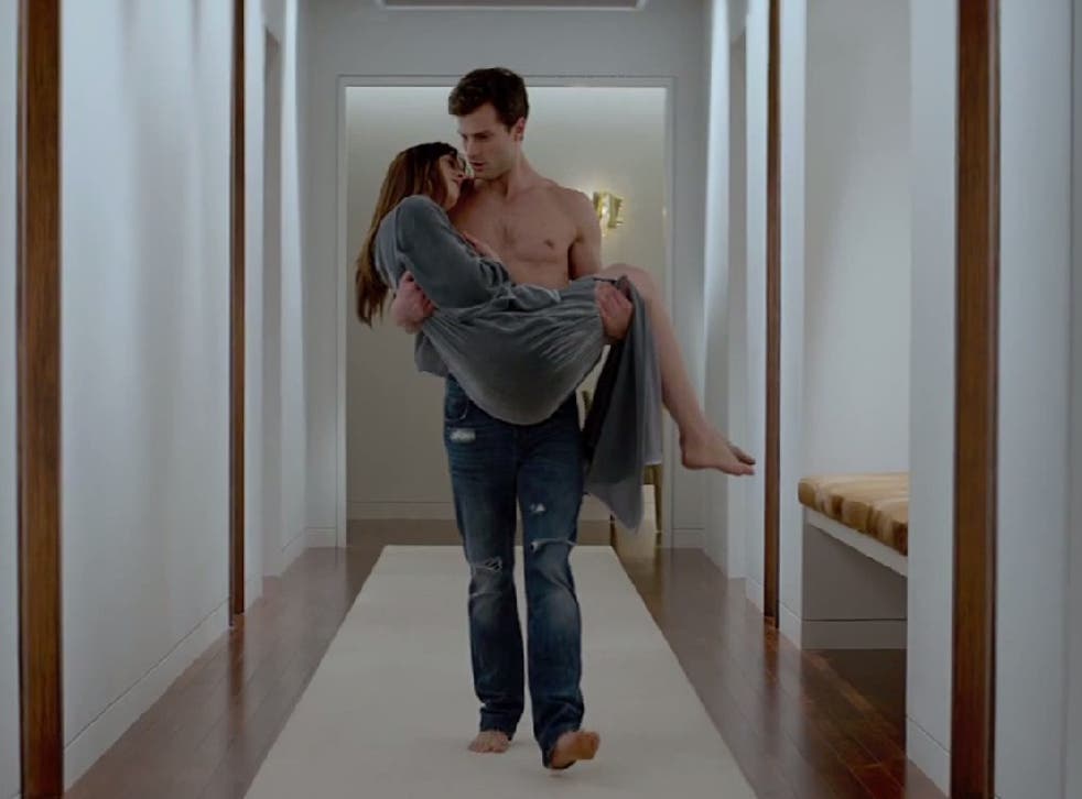Christian Grey cradles Ana in the Fifty Shades of Grey film