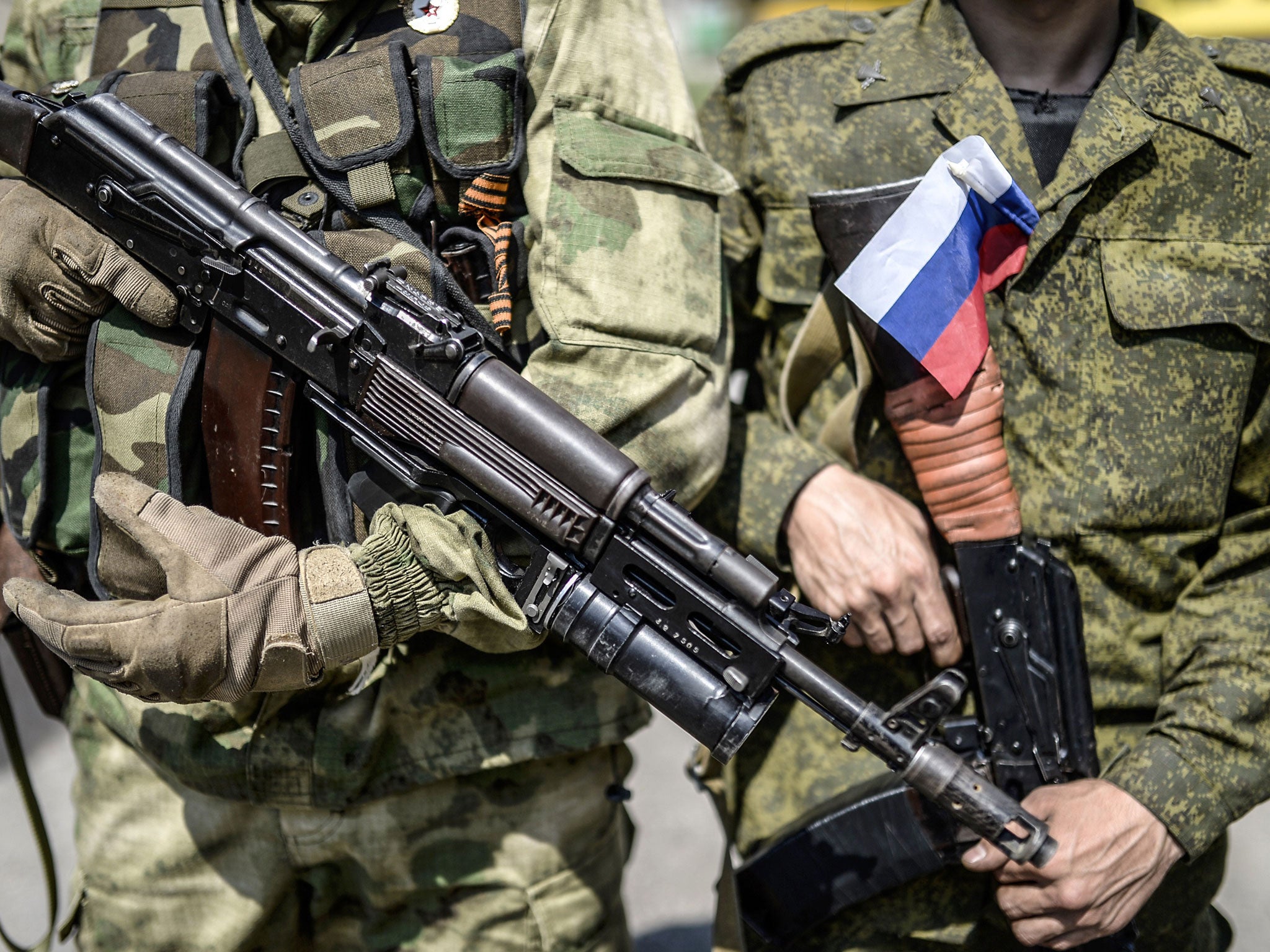 A pro-Russia separatist with a Russian national flag attached on his uniform. The US said on Thursday it has 'new evidence' Russia has been firing artillery from within its territory into Ukraine.