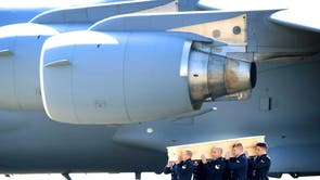 Dutch military personnel carry a coffin containing the remains of the victims of the MH17 plane crash to a hearse at the airbase in Eindhoven, The Netherlands. A Dutch Air Force C-130 Hercules plane and an Australian Royal Australian Air Force C17 transport plane brought back 74 more coffins containing remains of the victims of the Malaysia Airlines MH17 plane crash, from Kharkiv in eastern Ukraine to the Eindhoven air base in the Netherlands