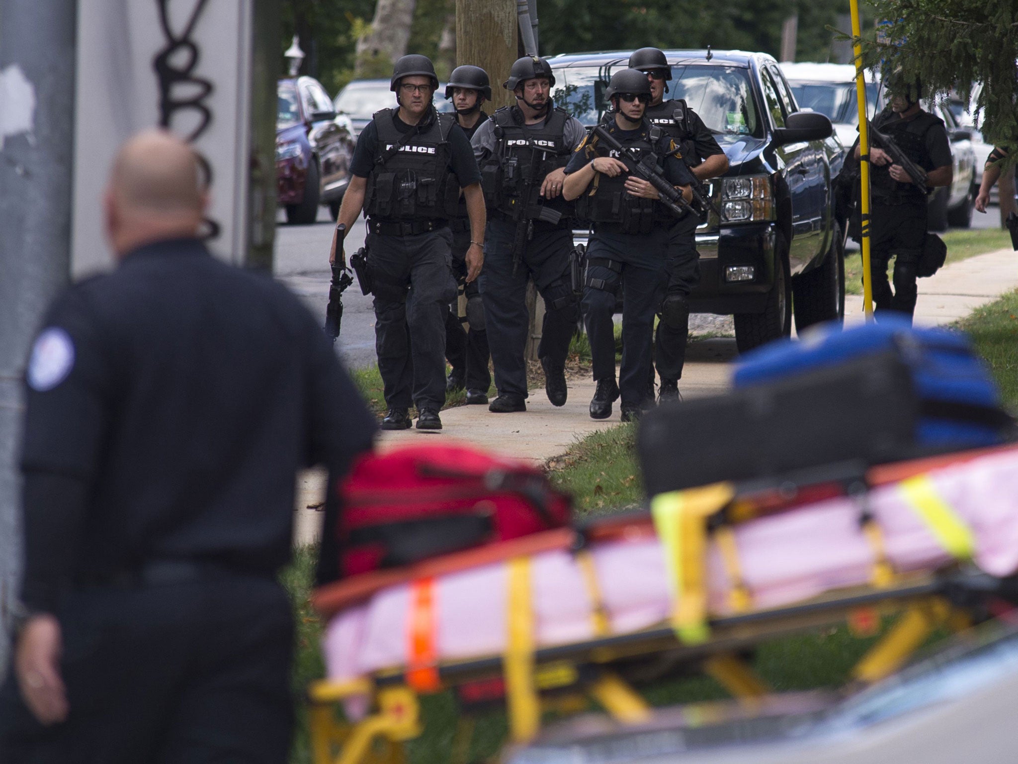 Police gather at the scene of a shooting at the Mercy-Fitzgerald Hospital in Darby, Pennsylvania on July 24, 2014. A gunman opened fire inside a Pennsylvania psychiatric facility on Thursday, killing a woman and wounding a doctor before he was shot and cr