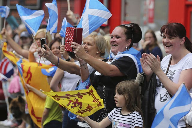 Spectators gather to watch the Queens Baton Relay