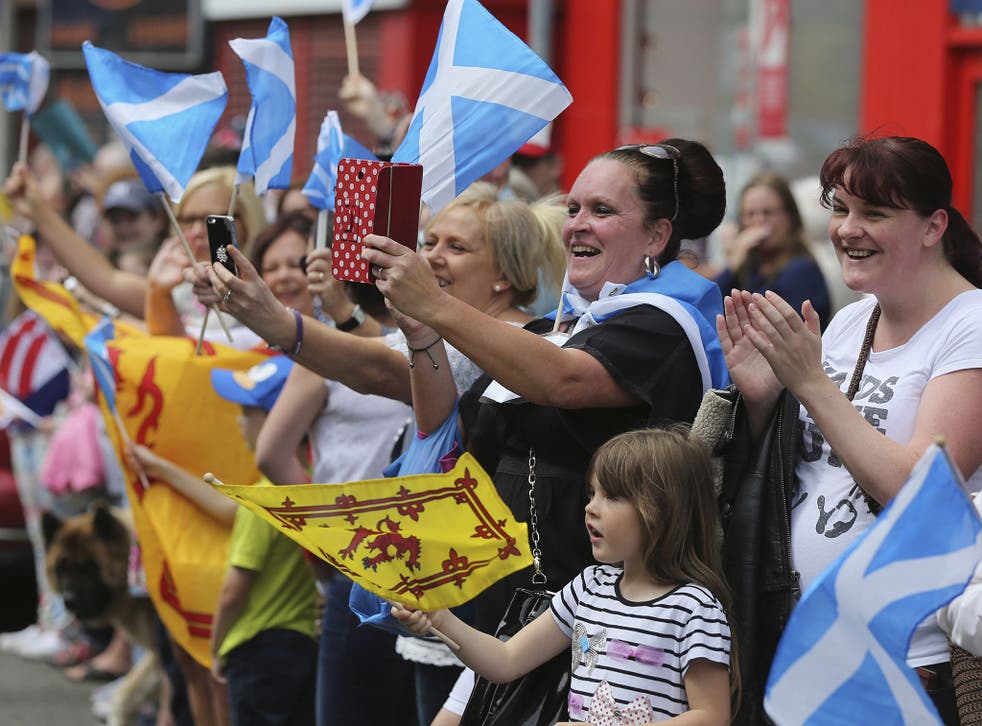 Spectators gather to watch the Queens Baton Relay