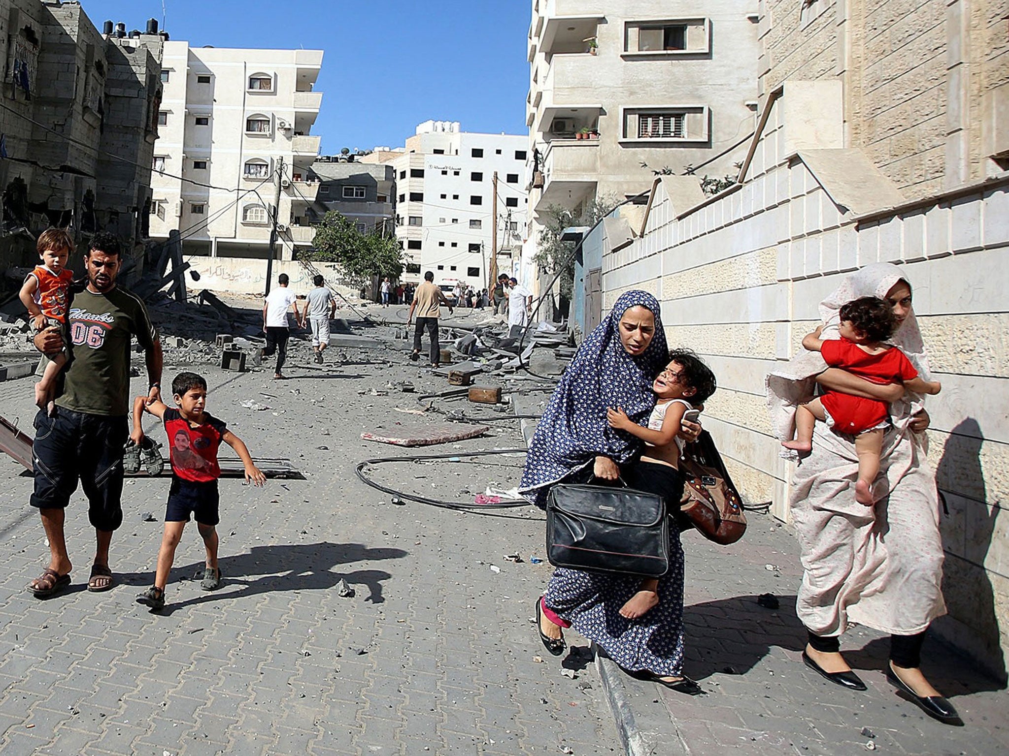 Palestinians flee from Israeli air strikes in Gaza City yesterday