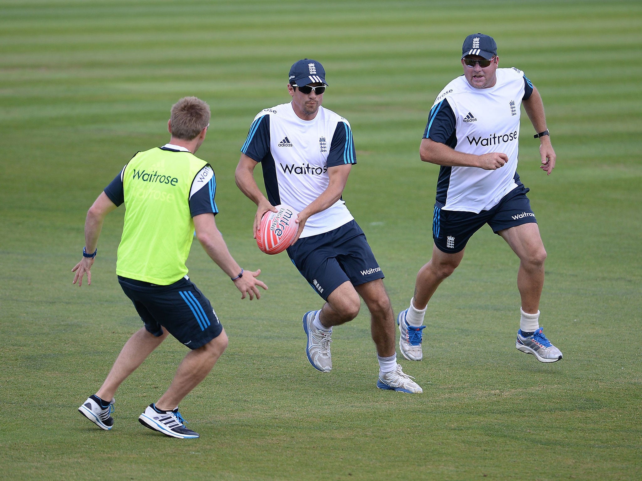 Alastair Cook tries his hand at rugby during yesterday’s
training session at the Ageas Bowl