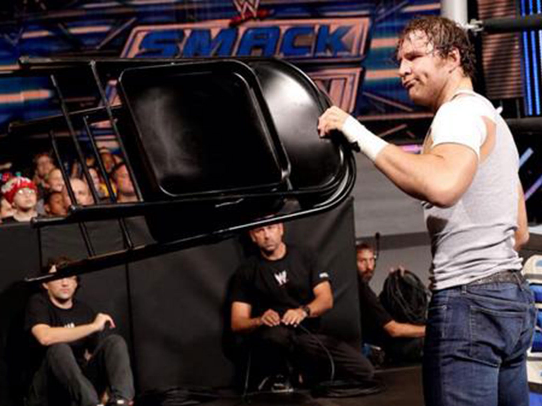 Dean Ambrose uses a chair during his match against Cesaro