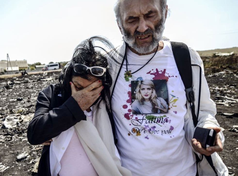 Jerzy Dyczynsk (R) and Angela Rudhart-Dyczynski from Australia react as they arrive on July 26, 2014 at the crash site of the Malaysia Airlines Flight MH17 to look for their late daughter Fatima