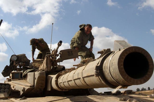 Firepower: An Israeli tank takes aim on the Gaza border yesterday