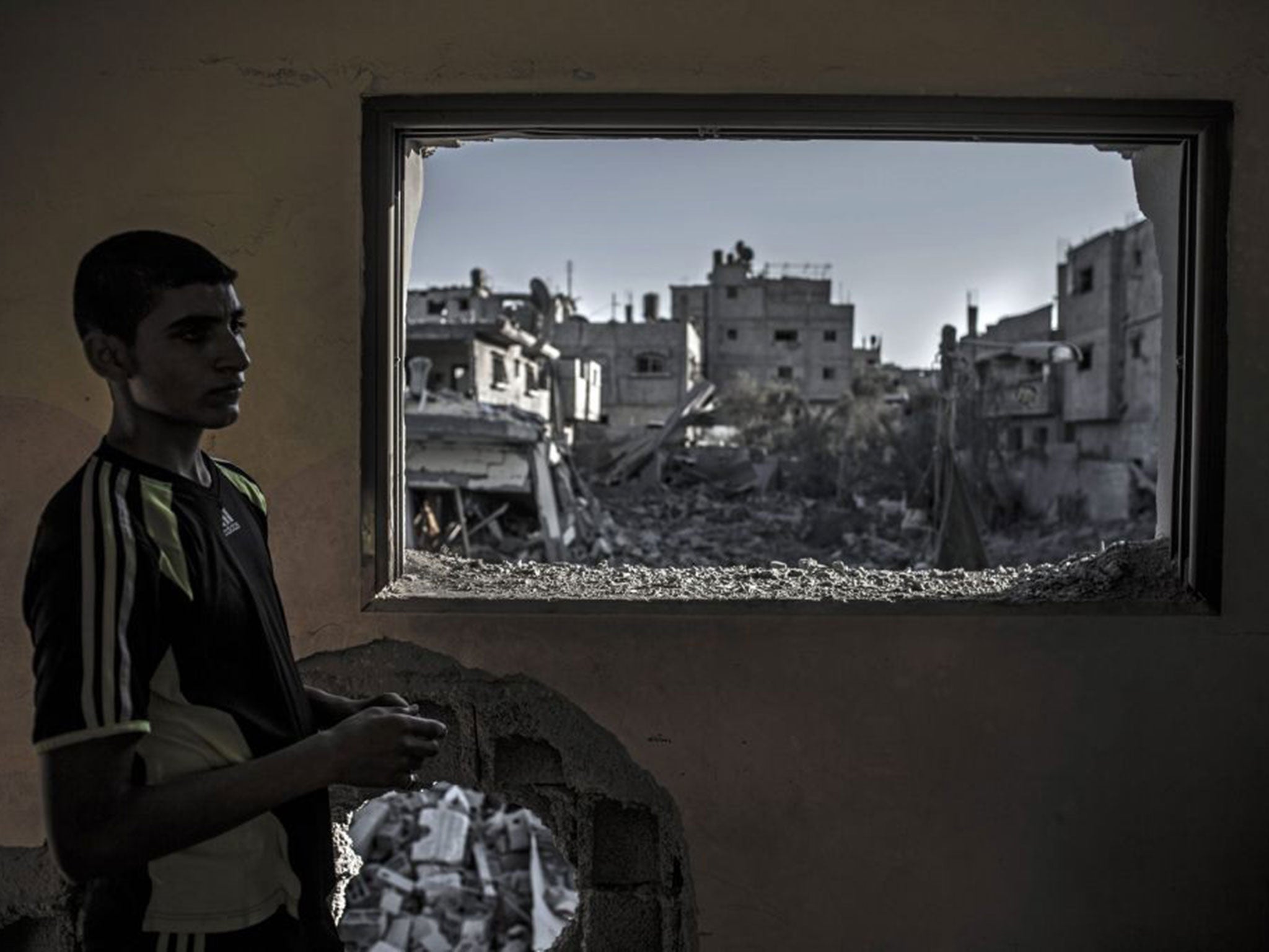 Gaza City: A young Palestinian man stands in his bombed bedroom