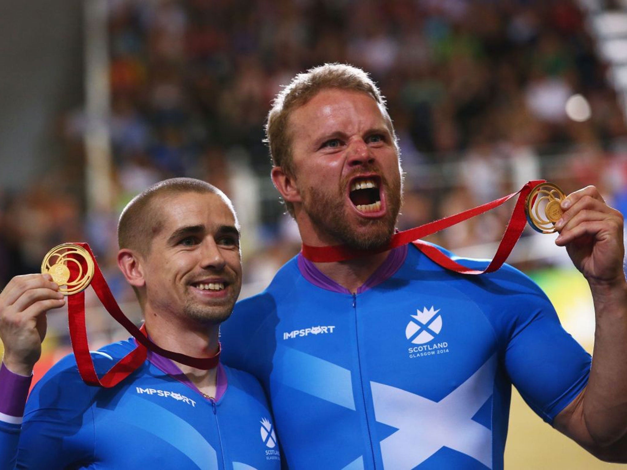 Twice blessed: Neil Fachie (left) and pilot Craig Maclean celebrate victory in the para-cycling sprint tandem, their second Commonwealth triumph in Glasgow