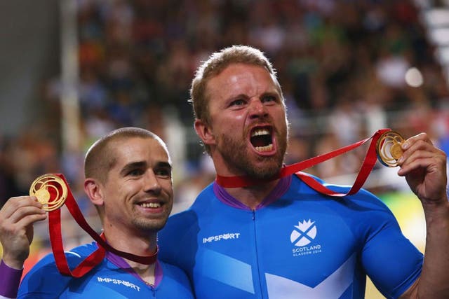Twice blessed: Neil Fachie (left) and pilot Craig Maclean celebrate victory in the para-cycling sprint tandem, their second Commonwealth triumph in Glasgow  