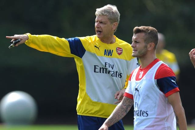Follow my leader: Jack Wilshere listens to manager Arsène Wenger