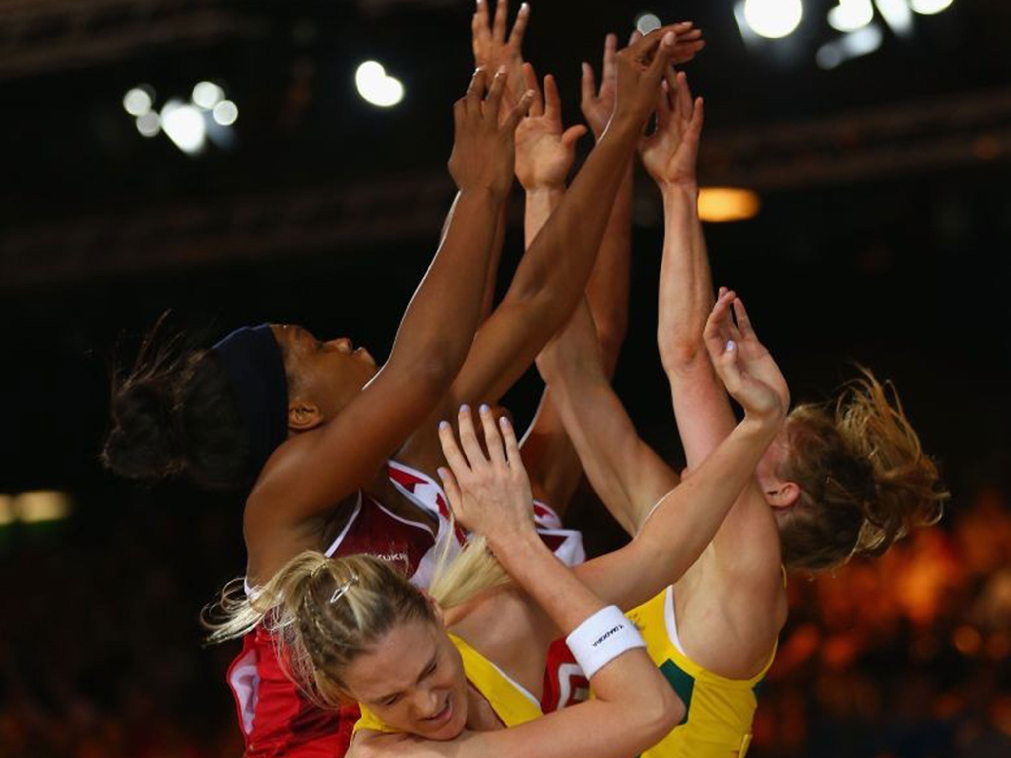 Gold rush: England (left) and Australia netball players challenge for the ball and potentially the ultimate prize