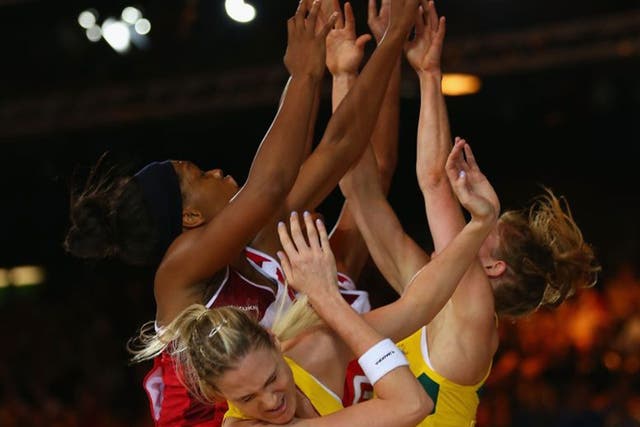 Gold rush: England (left) and Australia netball players challenge for the ball and potentially the ultimate prize  