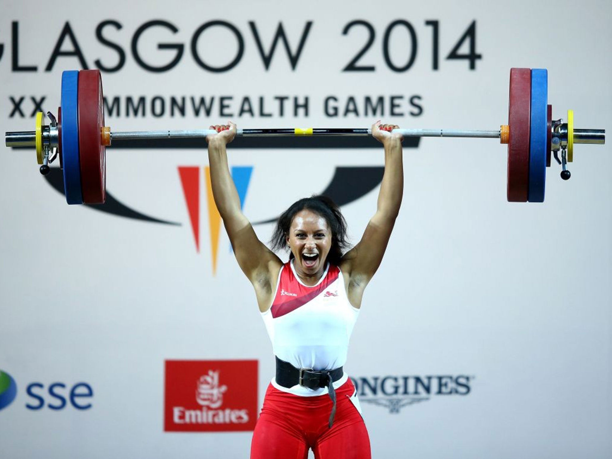 Raising the bar: Zoe Smith holds up a record-setting lift to capture a gold medal for England in the women’s 58kg event