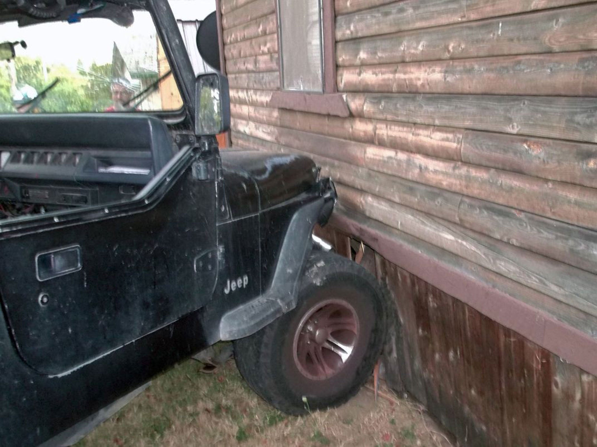 This photo provided by the Myrtle Creek Police Department shows a Jeep that authorities say a toddler crashed into an home in Myrtle Creek, Ore