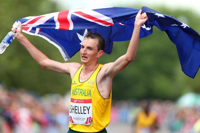 Michael Shelley of Australia celebrates as he crosses the line to win the Men's Marathon