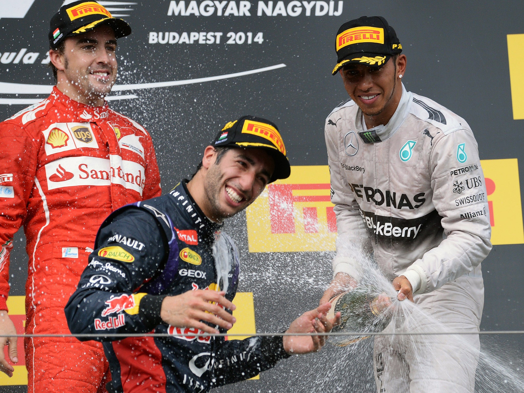 Red Bull Racing's Australian driver Daniel Ricciardo (C) celebrates with Scuderia Ferrari's Spanish driver Fernando Alonso (L) and Mercedes' British driver Lewis Hamilton