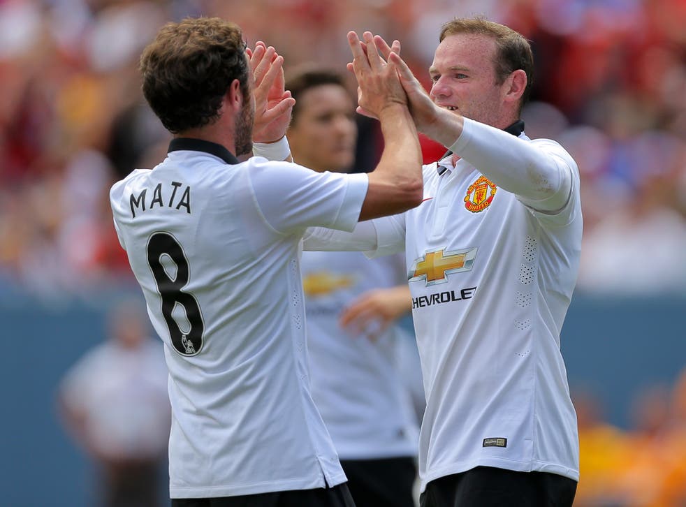 Juan Mata and Wayne Rooney celebrate during the 3-2 win over AS Roma