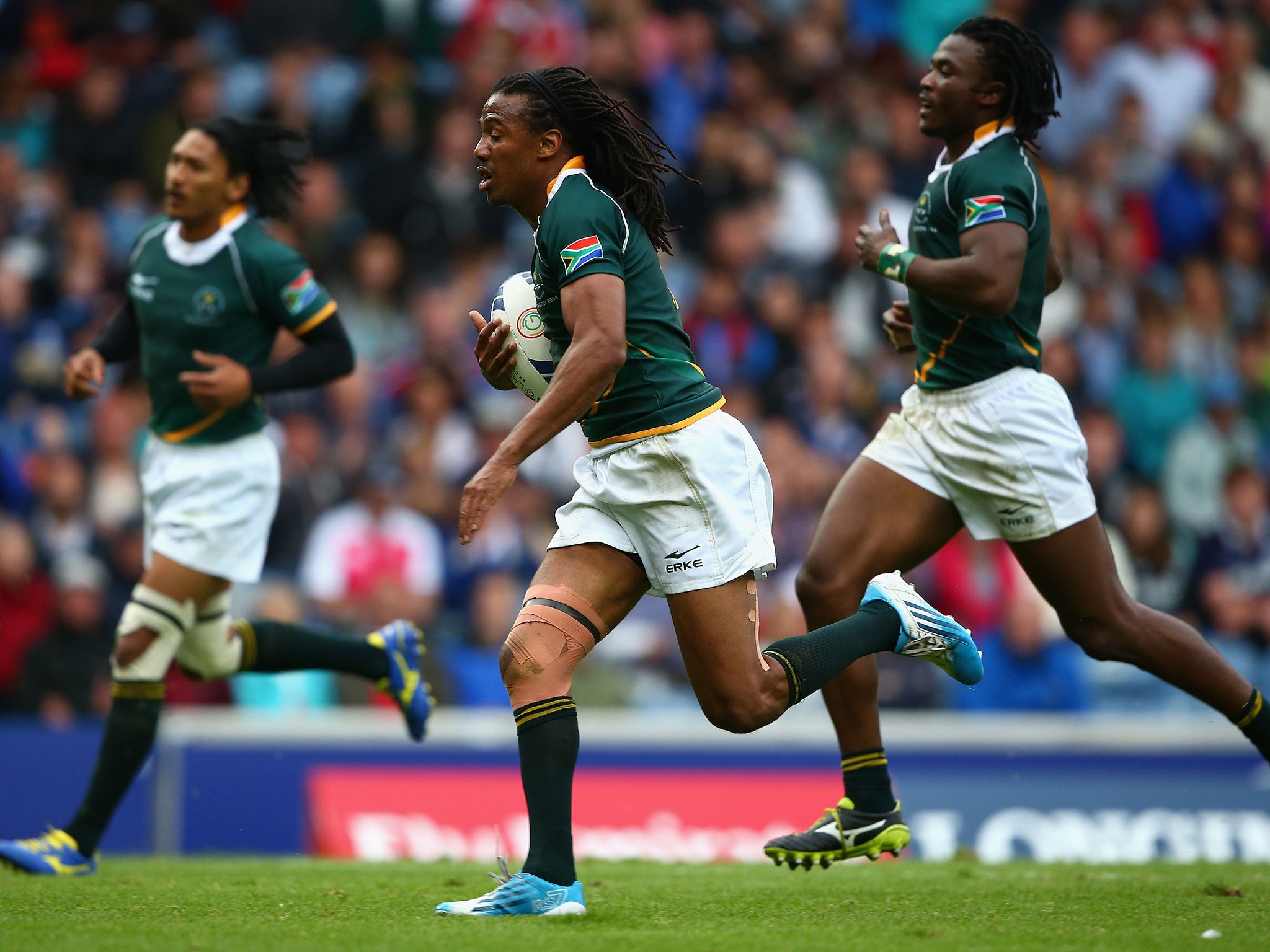 Cecil Afrika, of South Africa, goes over for a try during the Rugby Sevens tournament