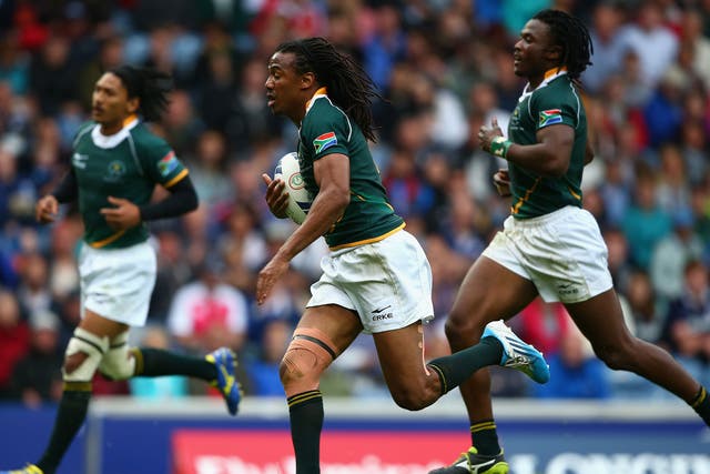 Cecil Afrika, of South Africa, goes over for a try during the Rugby Sevens tournament