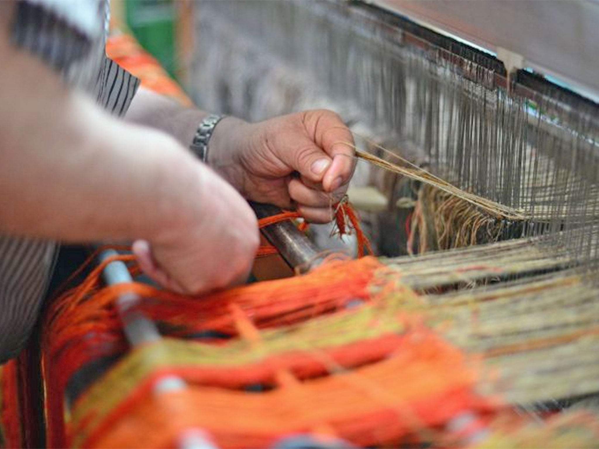 John Murdo Macdonald tying in a double width loom at the Harris Tweed Hebrides Company in Shawbost in Stornoway, Scotland