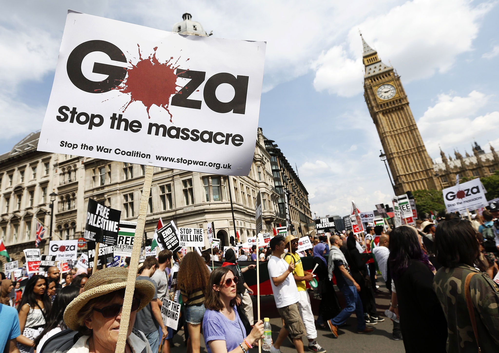 Demonstrators march through the streets from outside the Israeli embassy in central London on July 26, 2014, calling for an end to violence in Gaza.