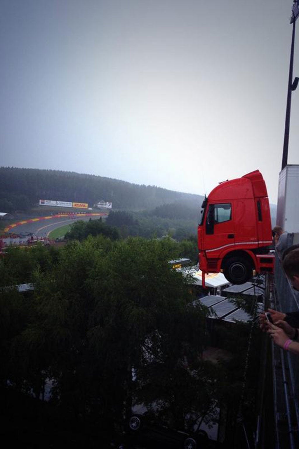 A truck hangs on the edge of a hefty drop at the Spa-Franchorchamps track
